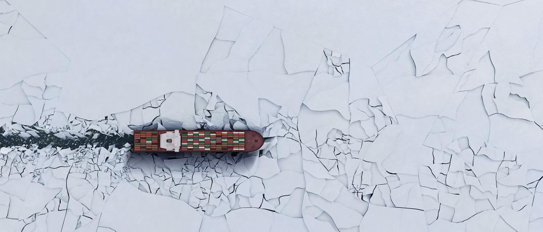 A shipping tanker advances steadfastly through shifting Arctic sea ice.