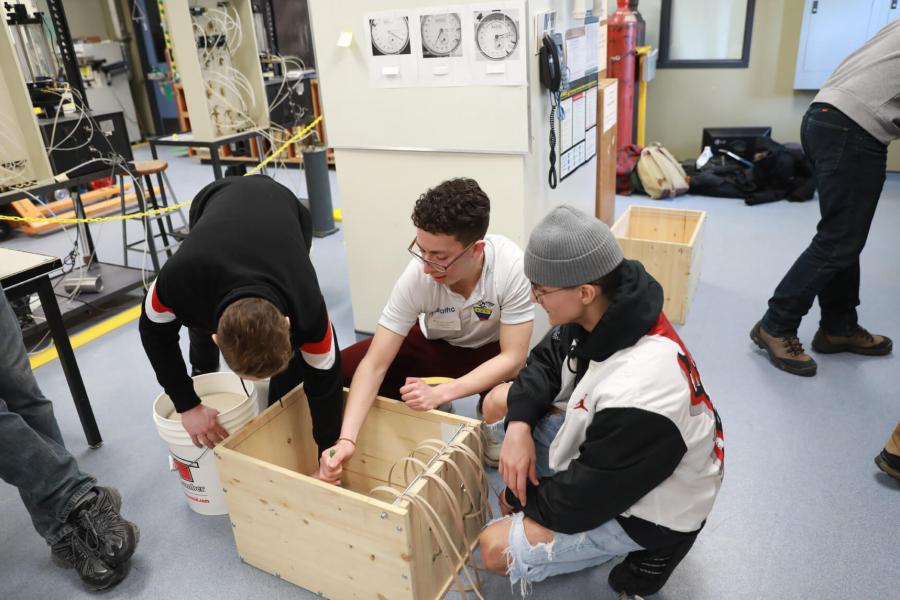 Three SET Day participants  in a lab working together.