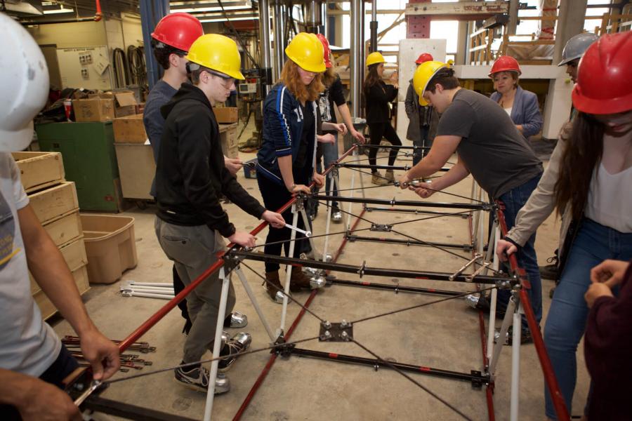 SET Day participants working together to assemble a structure.