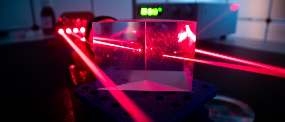 Experiment with red laser in optics lab.