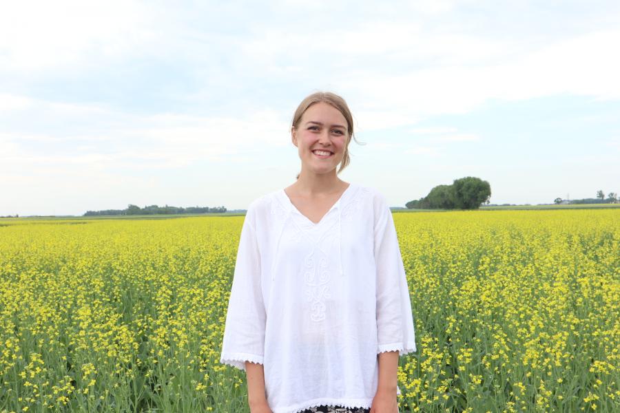 Lettie, student in Genetics, standing in a field