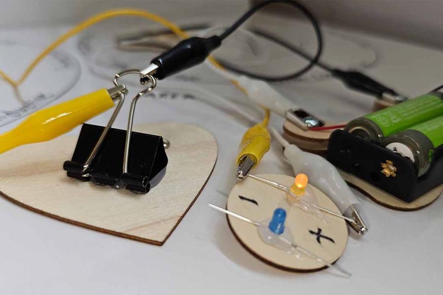 Wooden board with small lights and wires.