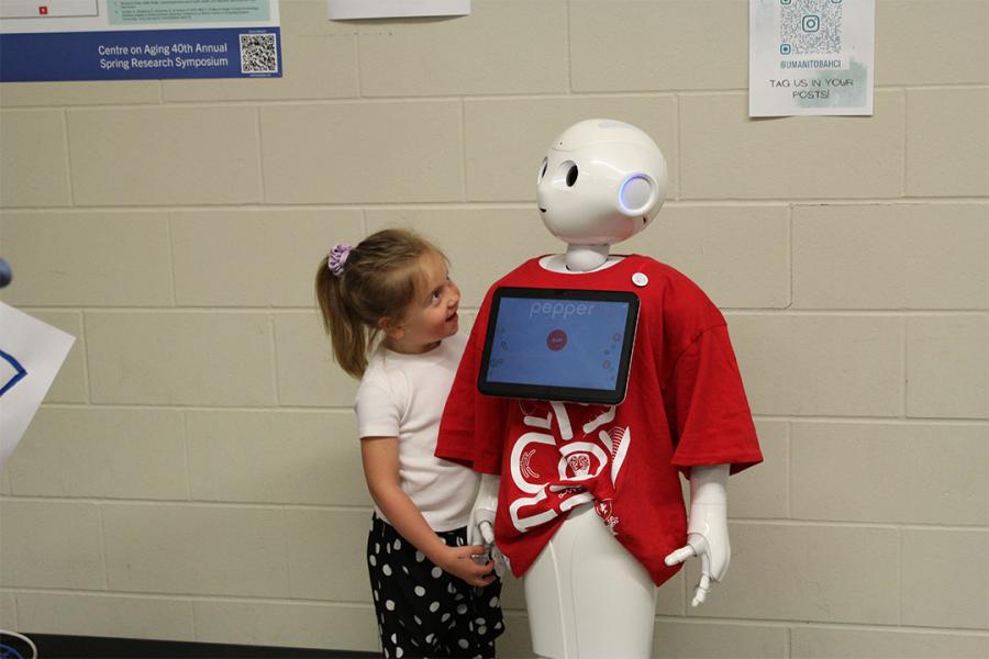 A kid interacting with the Pepper robot at Science Rendezvous.
