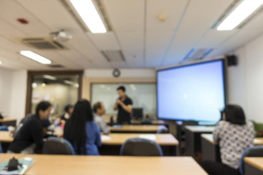 a group of student having a meeting with a projector screen