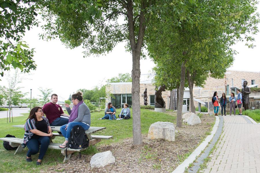 exterior shot of the bald eagle with different groups of people talking to each other