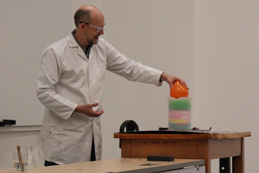 Scientist showing a chemistry experiment with a balloon.