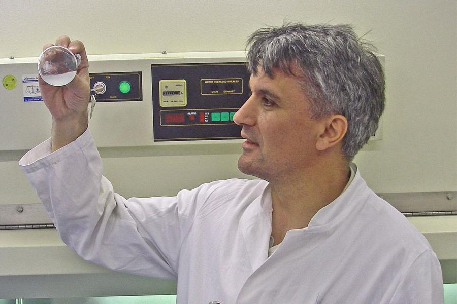 Nad Budisa wearing a lab coat and working with lab equipments.