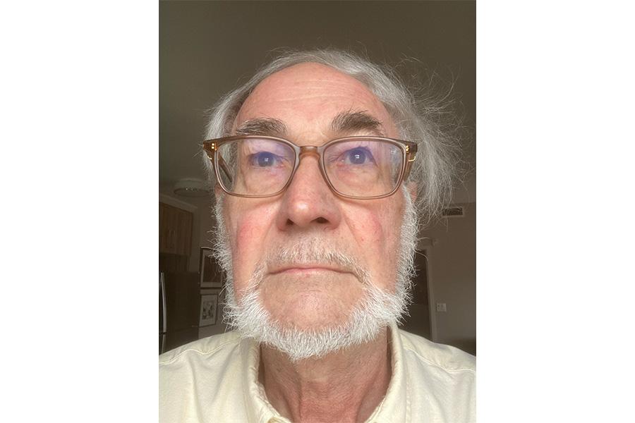 Peter Douglas Loly wearing an eyeglass and looking at the camera.