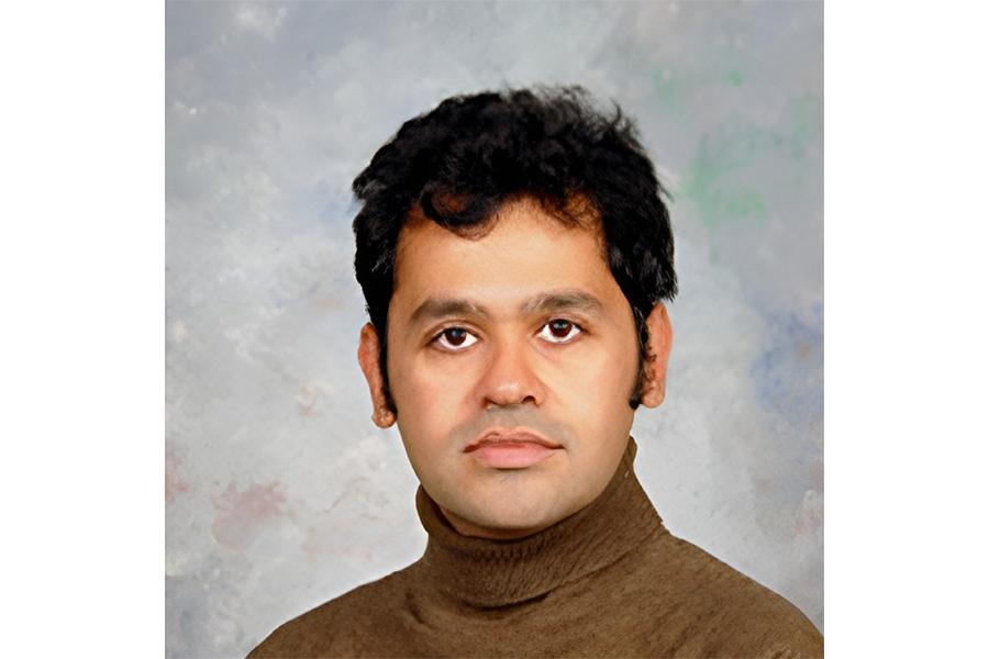 Jaydeep Chipalkatti wearing a brown shirt and looking at the camera.