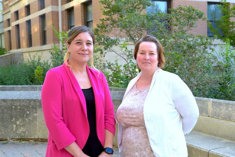 Melanie Lalonde wearing pink coat  and Carrie Selin wearing a white cardigan with a floral blouse.