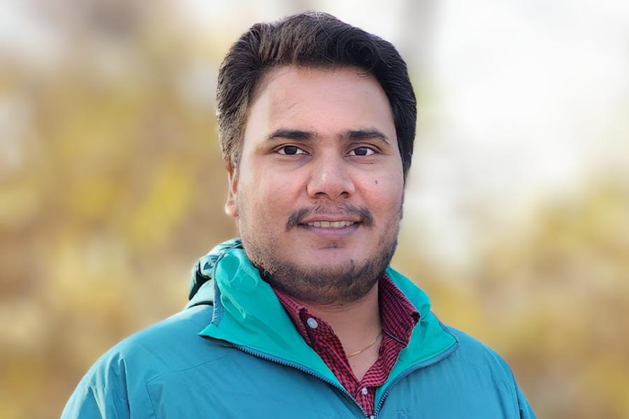 Vidyanshu Mishra wearing a turquoise jacket and smiling at the camera.