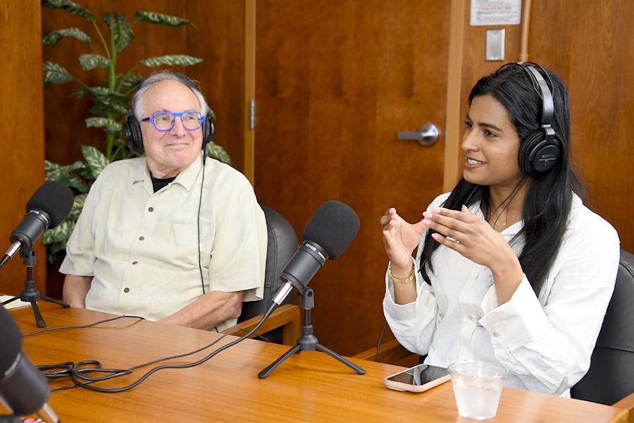 Erwin looking at Nishita while she shares her thought during the podcast.