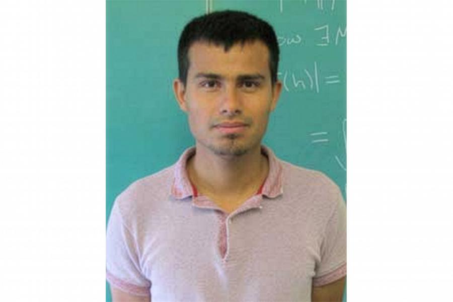 John Lopez Santander wearing a shirt with collar looking at the camera.