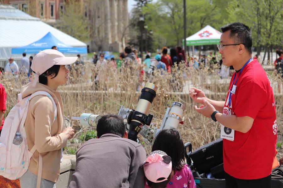 People looking through solar telescopes.
