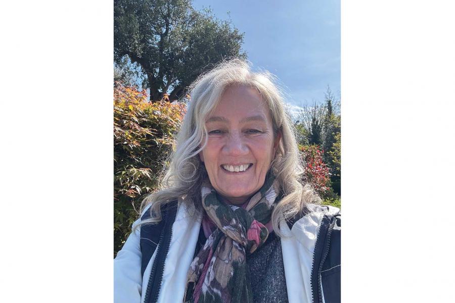 Kathleen Gough wearing a scarf and smiling at the camera.