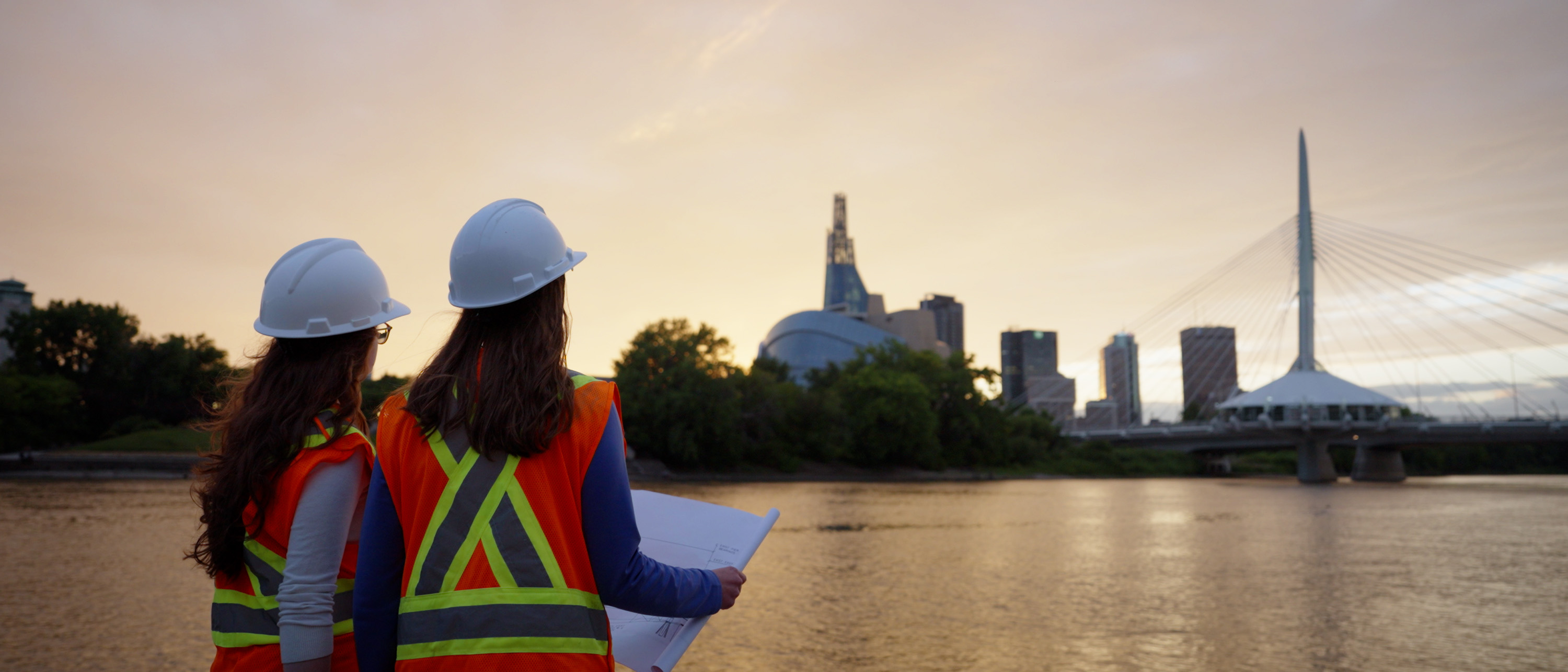 two engineers looking at the winnipeg skyline