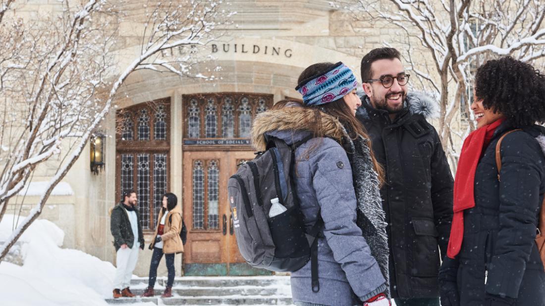 International students in front of University of Manitoba Tier building.