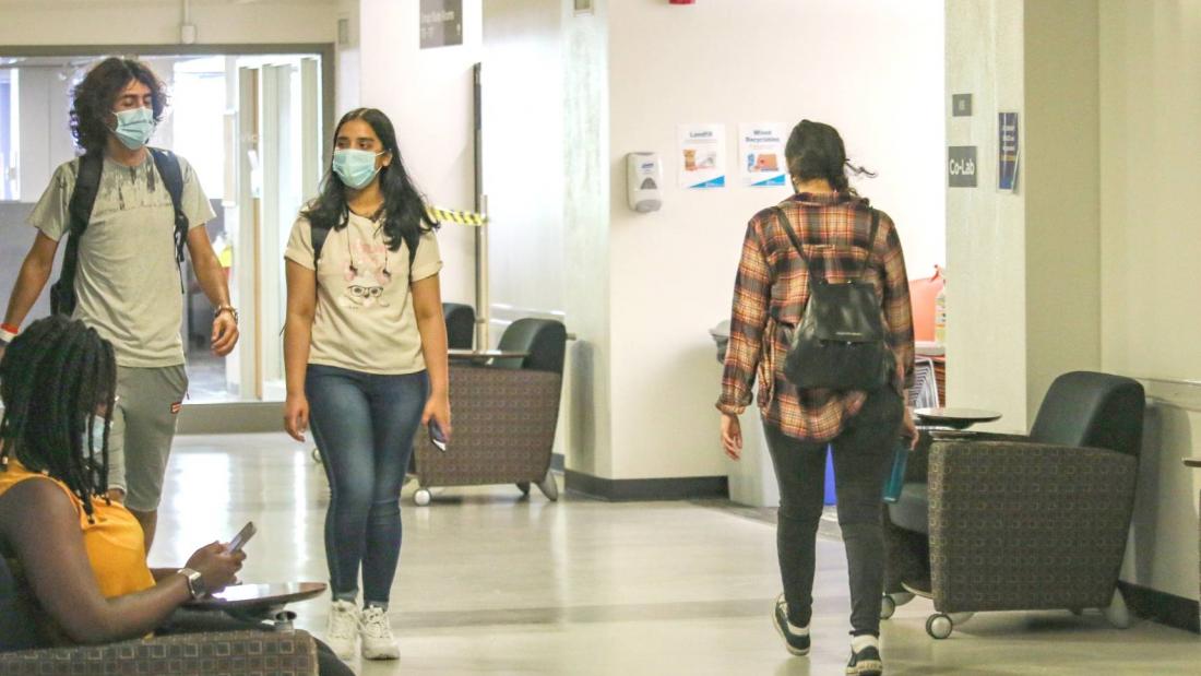 Students wearing masks walking in hallways