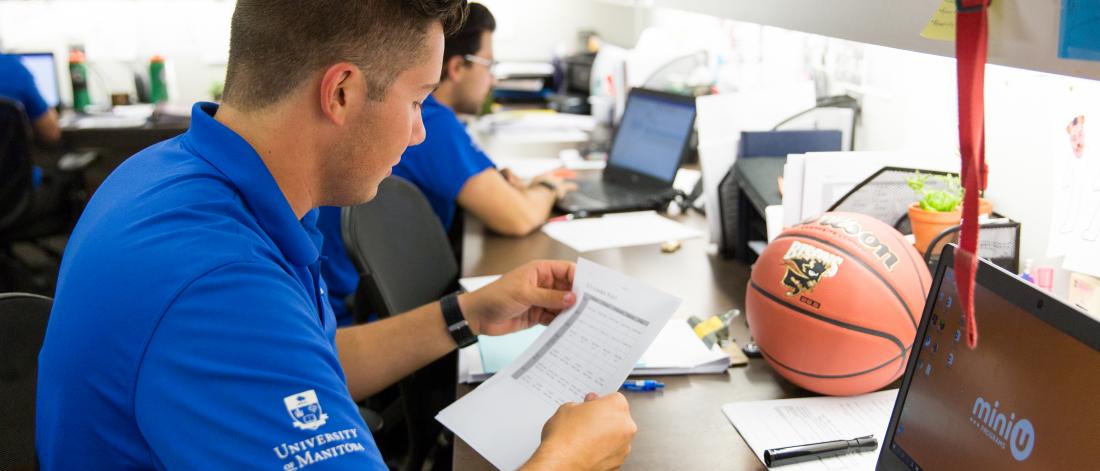 University of Manitoba employee reviewing a document