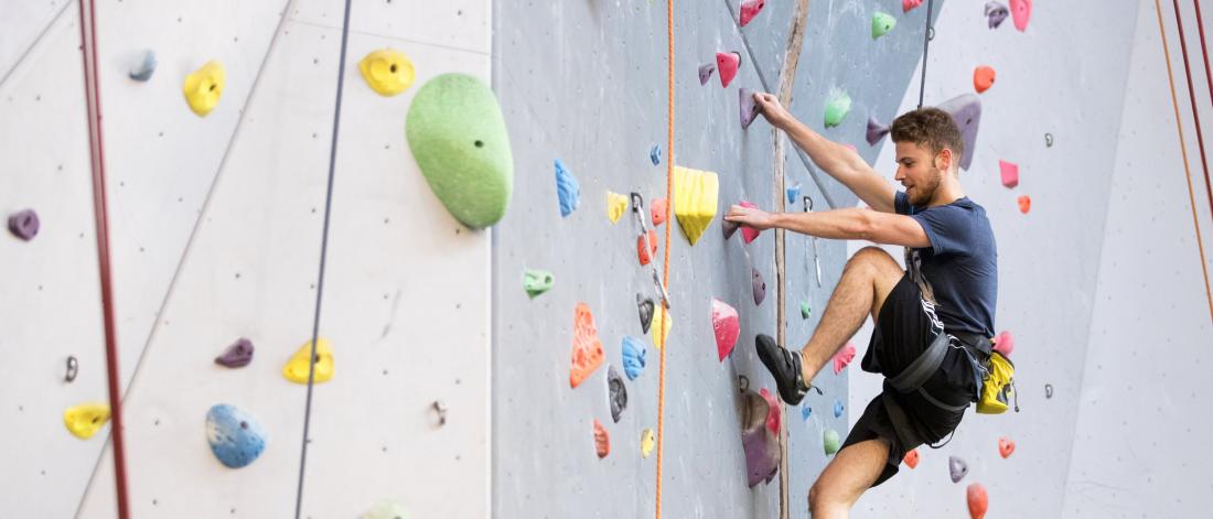 An Active Living Centre member scales the climbing wall.