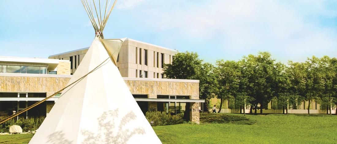 Migizii Agamik at the University of Manitoba with a tipi in the foreground.