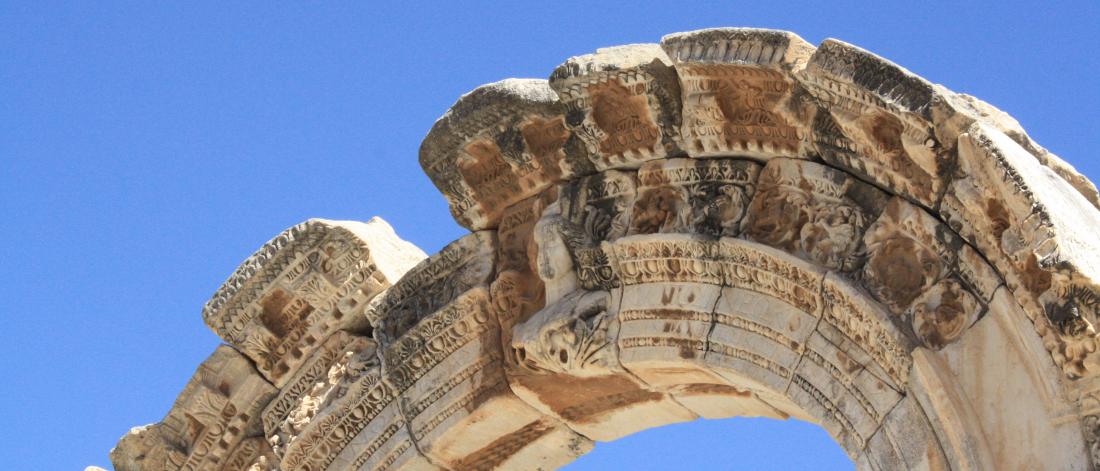 Ancient greek archway against blue sky