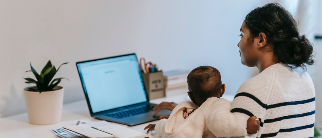 Mother Carrying Her Baby while Working From Home