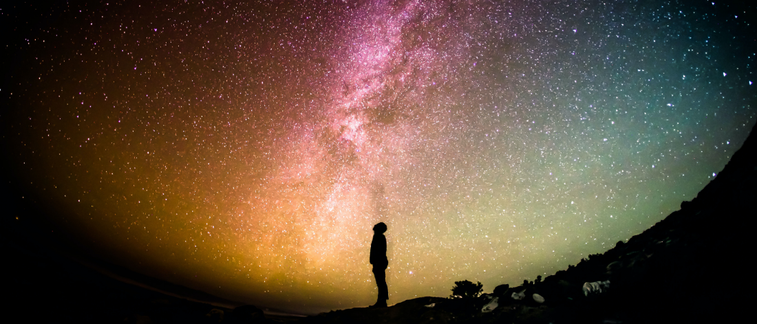 Person observing the night sky and milky way.