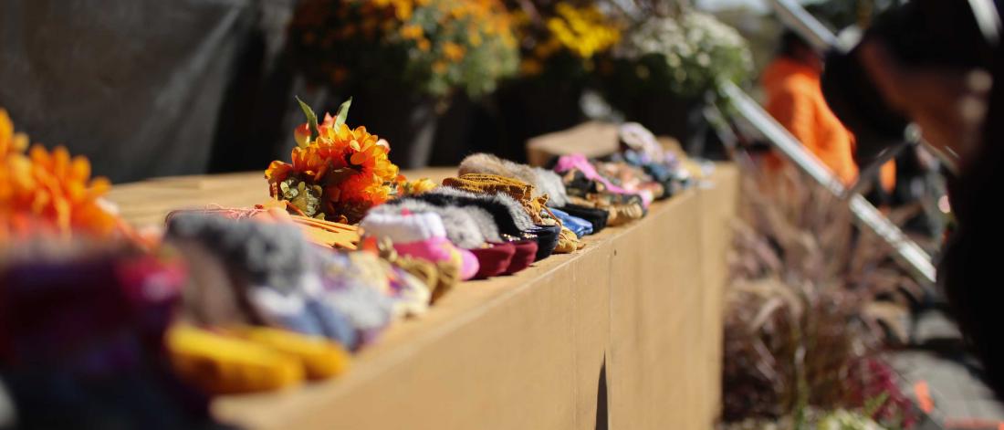 A close-up of dozens of child-sized moccasins lined up and on display at a National Day for Truth and Reconciliation.