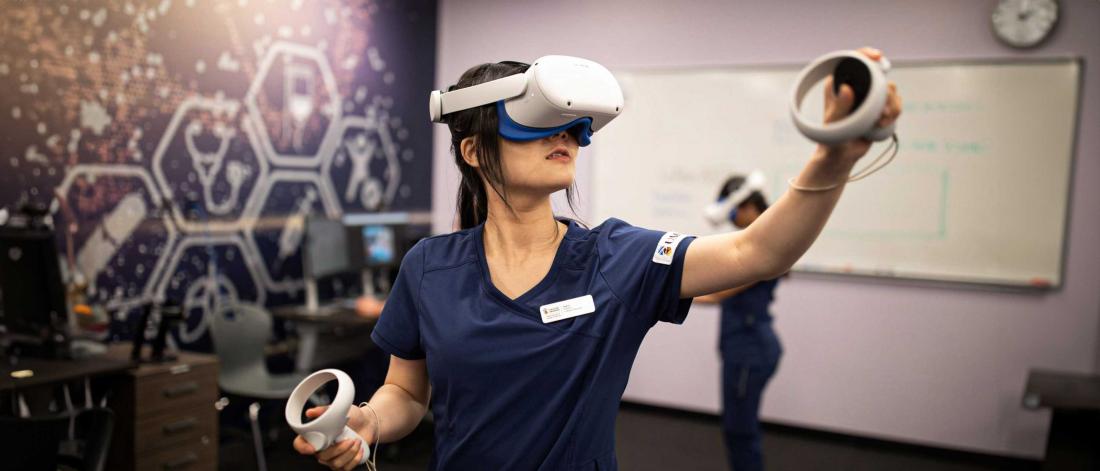 A nursing student wearing a virtual reality headset.