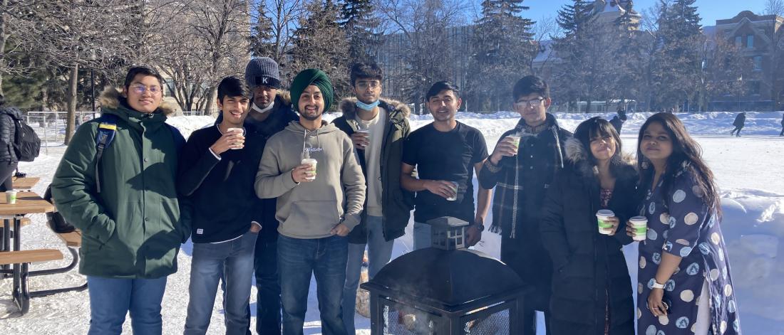 students in a group drinking hot chocolate outside 