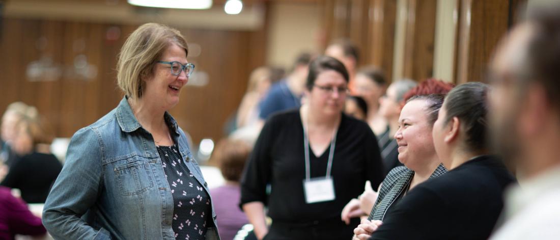 Staff visiting at a conference