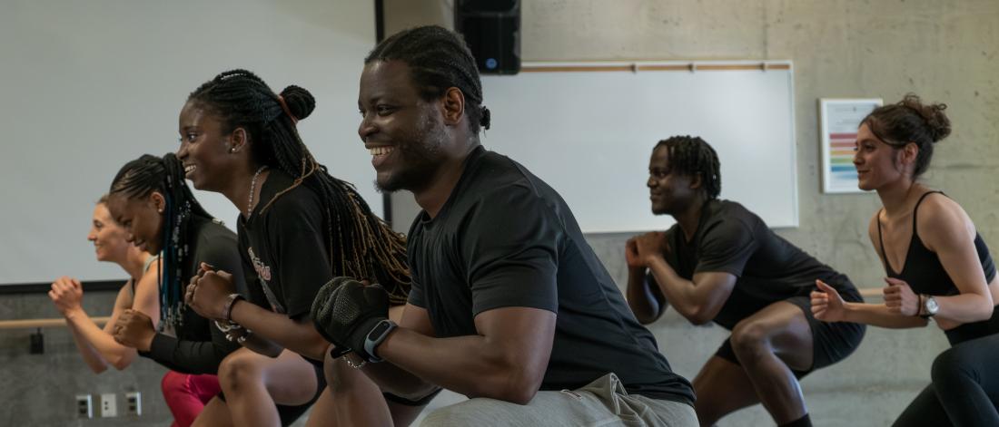 A young man smiling during a step class