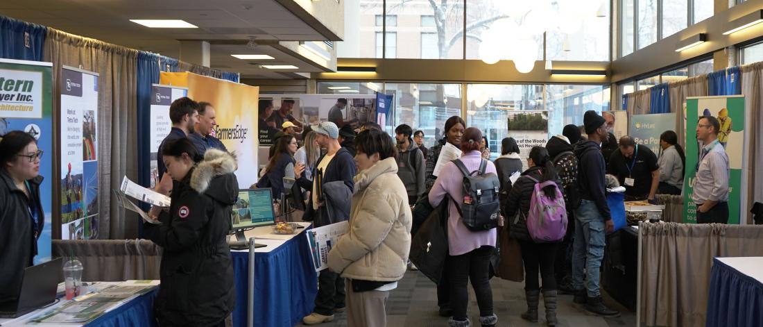 UM students at the Career Fair booths engaging with employers 