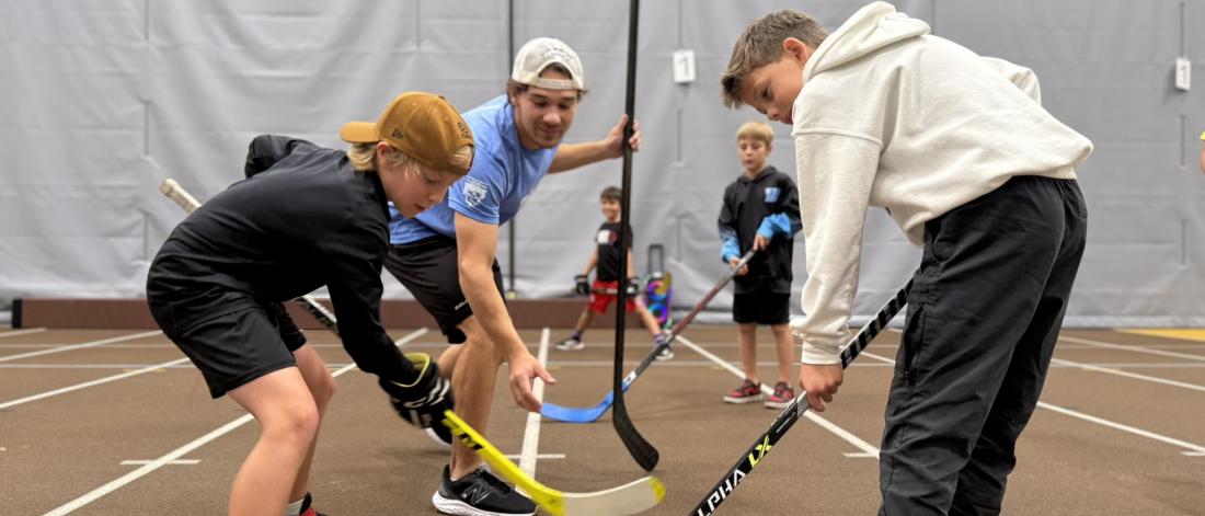 participants playing ball hockey