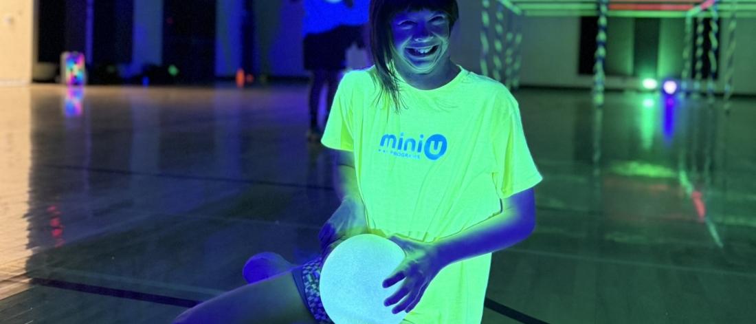 child sitting in a glow in the dark room