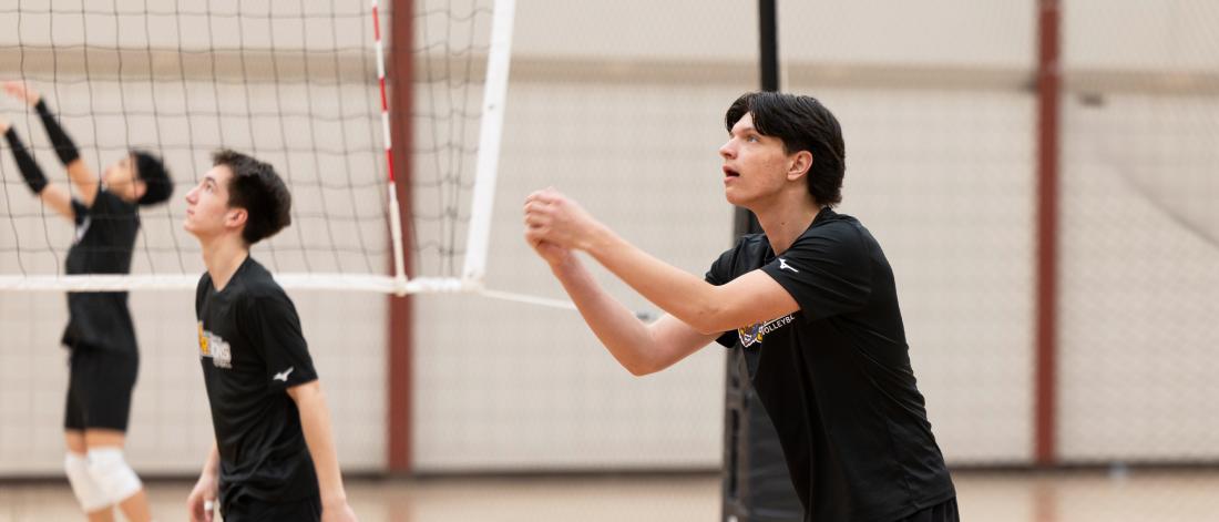 Boys warm up for a volleyball game.