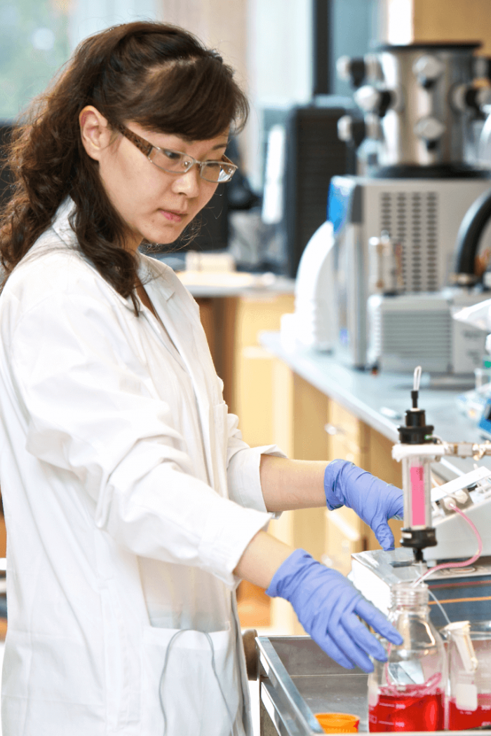 A pharmacy student works with equipment in a lab.