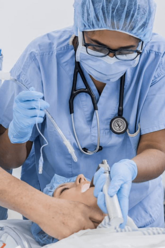 A student practices intubating a patient. 