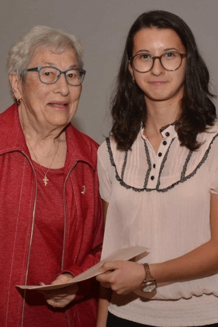 Two women standing side by side for a photo. 