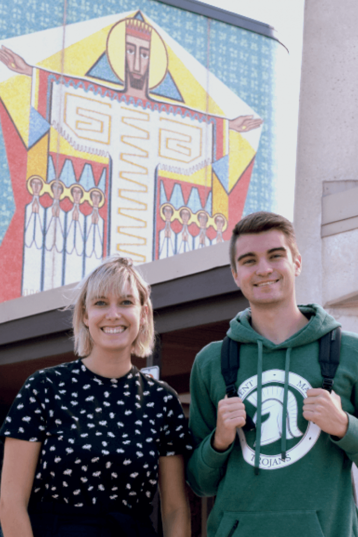 Two students stand side by side outside of St. Pauls College.