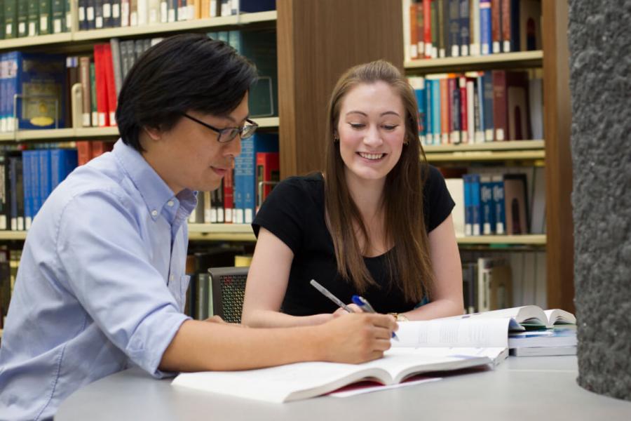 a man and a woman in a library working