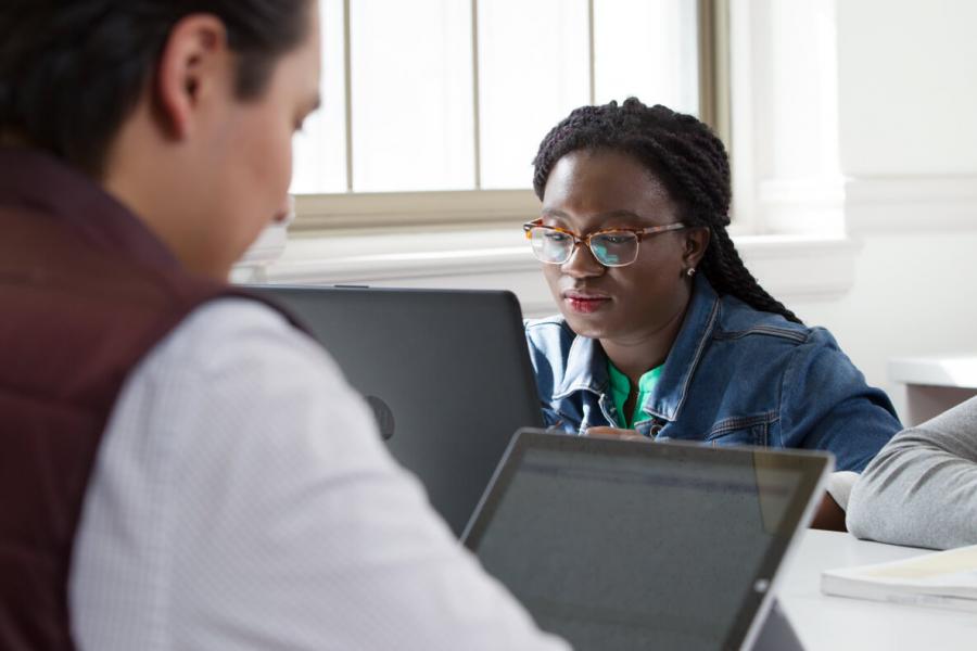 image of two students viewing laptop screens