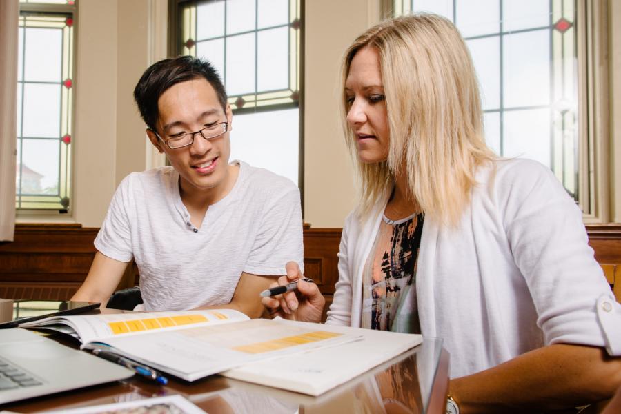 Two University of Manitoba staff working together.