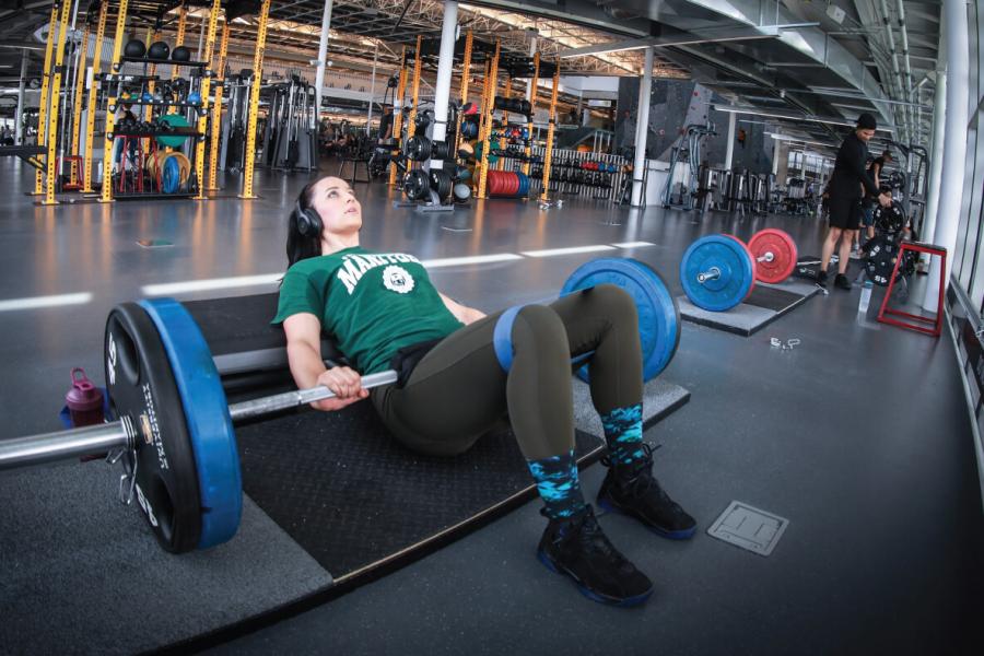 women lifting weights at a University of Manitoba recreation facility