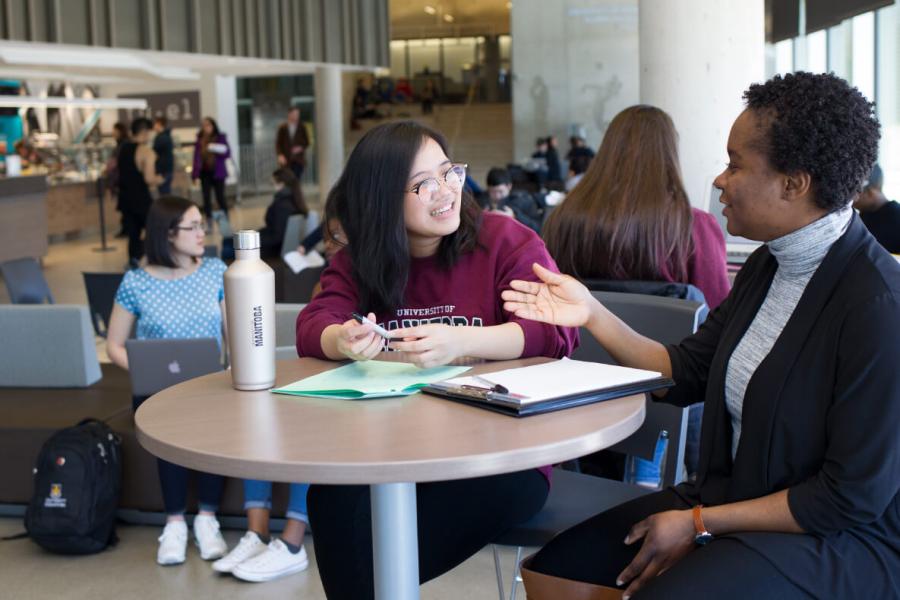 students reviewing notes in a cafe.