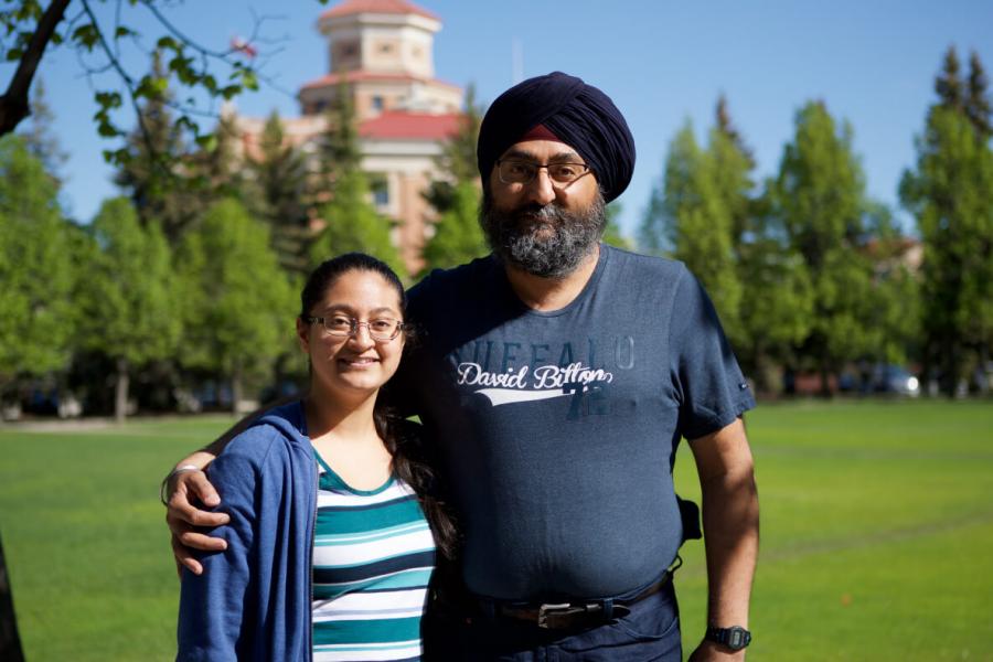 Father and daughter standing outside