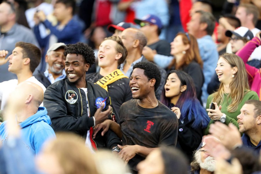 Excited students in a crowd cheering on the University of Manitoba Bisons football team.