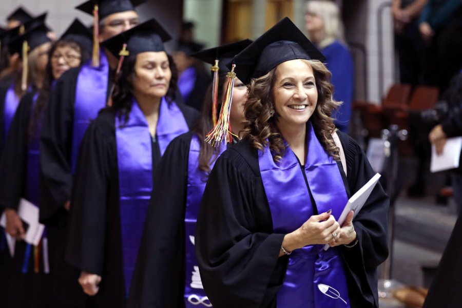 Students wait in line to receive their parchments on convocation day.