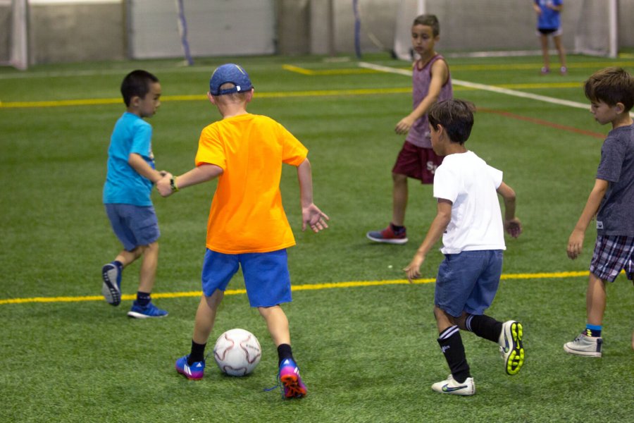 Opposing teams playing a game of soccer.